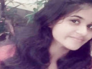 Web cam model with lengthy hair tempts viewers with nude  parts
