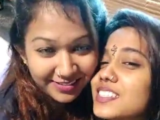 Sensuous girl/girl models share a romantic smooch in a sexy vid